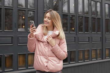 Sticker - Beautiful young woman using mobile phone outdoors