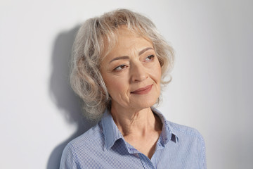 Wall Mural - Portrait of mature woman on grey background