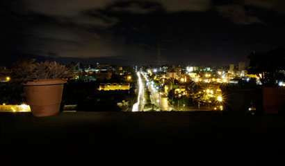 Alexandria Egypt city view from top roof of high building house, landscape with lights of road cars, blue clouds sky,  sea horizon at night time, top picturesque scenery