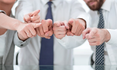 close up.a smiling business team pointing at you