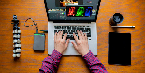 male producer edit video on his laptop in studio b