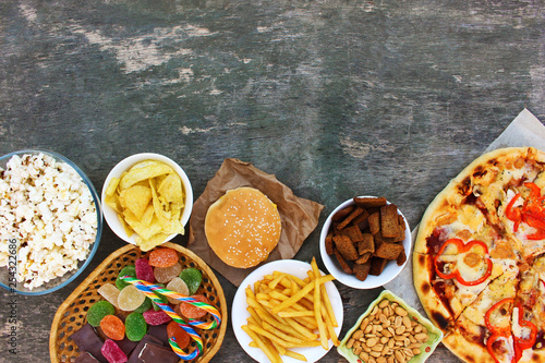 Fast food on old wooden background. Concept of junk eating. Top view. Flat lay. © Victoria М