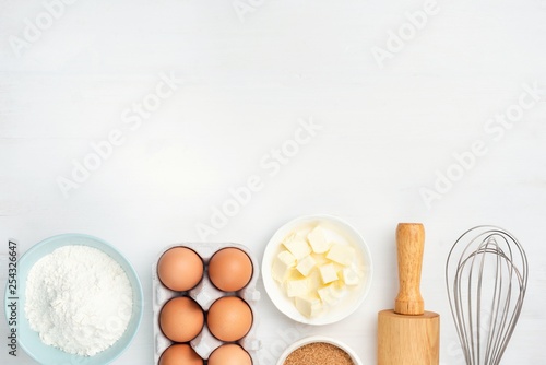 Fotomural Baking ingredients and kitchen utensils on white background