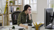 © PRPicturesProduction - Bored woman architect in glasses looking at desktop monitor in office. girl interior designer working thinking creative idea sitting at desk in workplace with no emotion. serious female employee