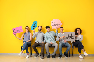 Poster - Young people holding speech bubbles with words JOB and CAREER indoors
