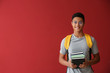 © Pixel-Shot - African-American schoolboy with books on color background