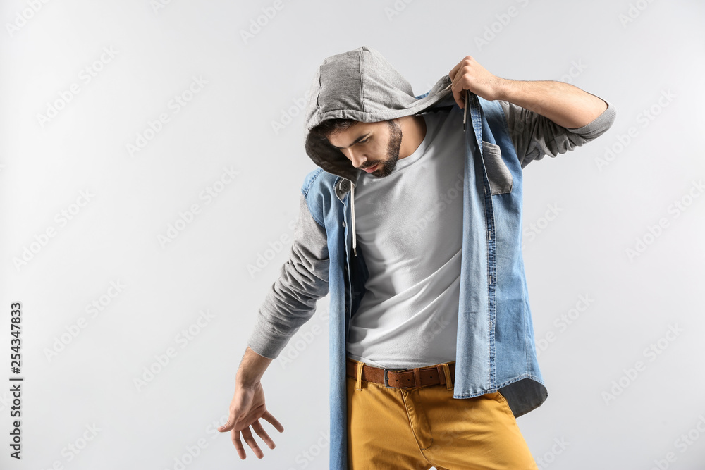 Fashionable young man on light background