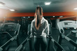 © Dusan Petkovic - Slim brunette in sweatshirt and ponytail standing on treadmill in gym at night. Backs turned. Do your best and forget the rest.