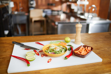 Wall Mural - Background image of Asian food ingredients on cutting board in restaurant kitchen, copy space