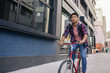 © mavoimages - Young man riding his bike on a city sidewalk