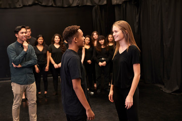 Wall Mural - Teacher With Male And Female Drama Students At Performing Arts School In Studio Improvisation Class