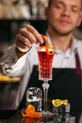 Wall Mural - Kir Royal cocktail with orange slice and ice cubes