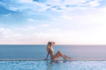 Wall Mural - girl on vacation relax in a tropical pool