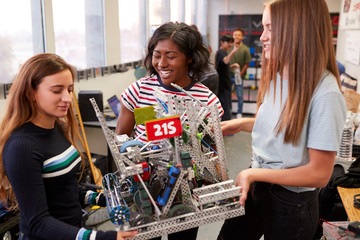 Wall Mural - Female University Students Carrying Machine In Science Robotics Or Engineering Class