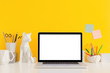 © mallmo - Laptop mac screen on a yellow background office workspace. Mock up.