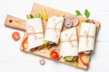 Sticker - Burritos tortilla wraps with beef and vegetables on white background.