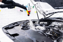 Car Detailing. Car Washing Cleaning Engine. Cleaning Car Using Hot Steam. Hot Steam Engine Washing. Soft Lighting. Car Washman Worker Cleaning Vehicle.