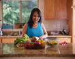 © Joshua Resnick - elderly thai woman cutting up vegetables in home kitchen to make a salad