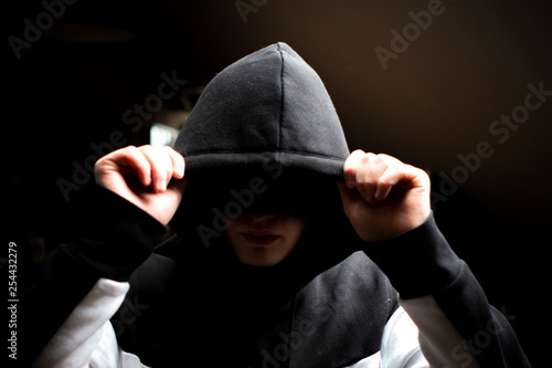 Fotomural anonymous man in the dark hood standing in the mysterious pose f