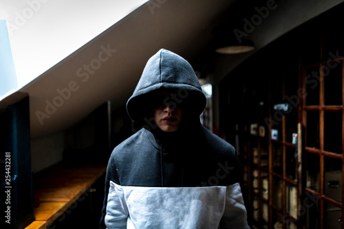 Fotografía anonymous man in the dark hood standing in the mysterious pose f