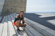 © KleverLevel - Muscular Male athlete sprinter resting after cross fit outdoor exercises. Healthy lifestyle
