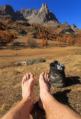 Poster - Feet of a hiker relaxing in the sun in the French Alps. Vallee de la Claree, Nevache.