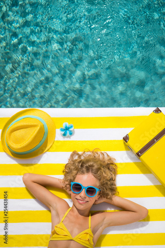 Top view portrait of child near the swimming pool