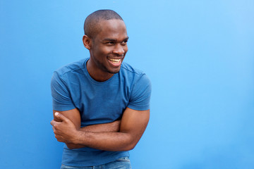 Wall Mural - handsome young black man laughing with arms crossed