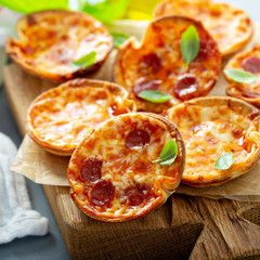 Wall Mural - Mini pepperoni and cheese pizzas with tomato sauce and mozzarella cheese