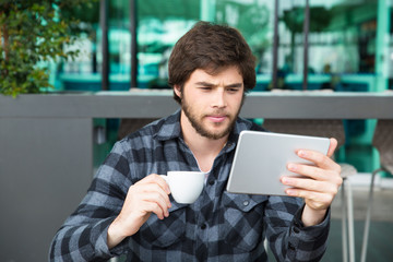 Wall Mural - Serious young entrepreneur checking up business news