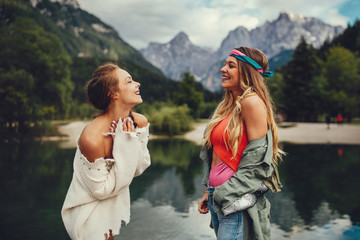 Wall Mural - Two young women tourist  have fun on the lake