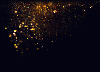 glitter vintage lights background. gold and black. de focused