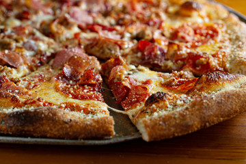 Wall Mural - Pepperoni and ham pizza fresh from the oven