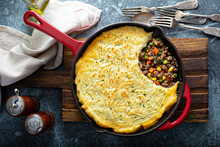 Shepherds Pie With Ground Meat, Vegetables And Potatoes In A Cast Iron Pan Top View