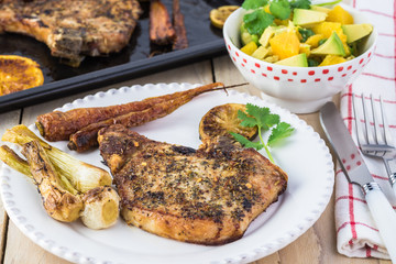 Wall Mural - Roasted pork chops and vegetables with avocado orange salsa