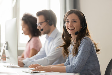 Wall Mural - happy businesswoman call center agent looking at camera at workplace