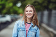 © Studio Romantic - A blond happy girl smiles in an urban style.