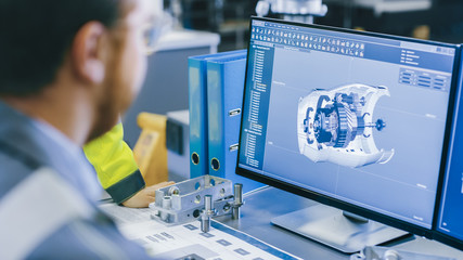 Poster - Close-up Back View of the Mechanical Engineer Designing 3D Engine Model on Personal Computer. Professional Working At the Factory.