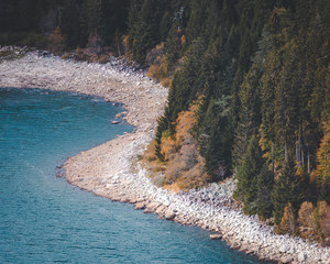 View of Lac Blanc from hiking trail zoomed in on lake egde. Beautiful bright blue mountain lake in Vosges, France