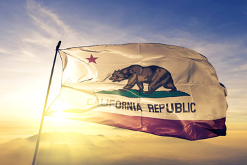 California state of United States flag waving on the top sunrise mist fog