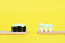 Bamboo Toothbrushes With Organic Toothpaste On Yellow Background