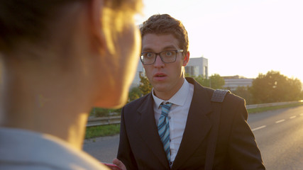 Wall Mural - LENS FLARE: Young businessman is shocked to see a gorgeous woman in gray suit.