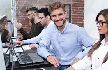 Wall Mural - smiling employee of the business center in the workplace