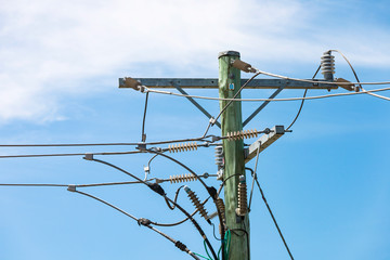 Power pole transforming electricity above street.