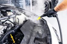 Car Detailing. Car Washing Cleaning Engine. Cleaning Car Using Hot Steam. Hot Steam Engine Washing. Soft Lighting. Car Washman Worker Cleaning Vehicle.