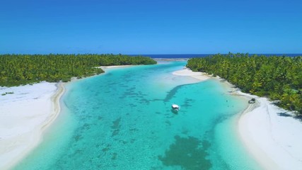 Wall Mural - DRONE: Locals having fun in the tranquil ocean by the beautiful paradise island by anchoring their boat and cooling off in the refreshing water. Tourist boat party stopping by the lush tropical island