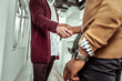 © Viacheslav Yakobchuk - African American guy in yellow sweater shaking hands with pale colleague