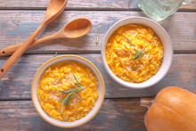 Delicious Pumpkin Risotto With Parmesan Cheese In A Bowl On On Wooden Background. Rustic Style