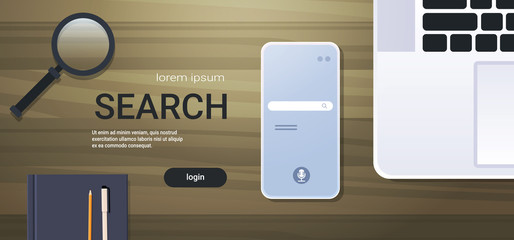 Wall Mural - mobile app browsing online search concept top angle view workplace desktop with laptop smartphone sc