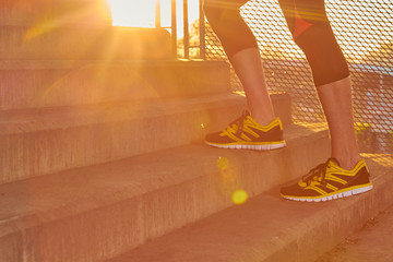 Sportsman working out / jogging on a big city urban bridge.